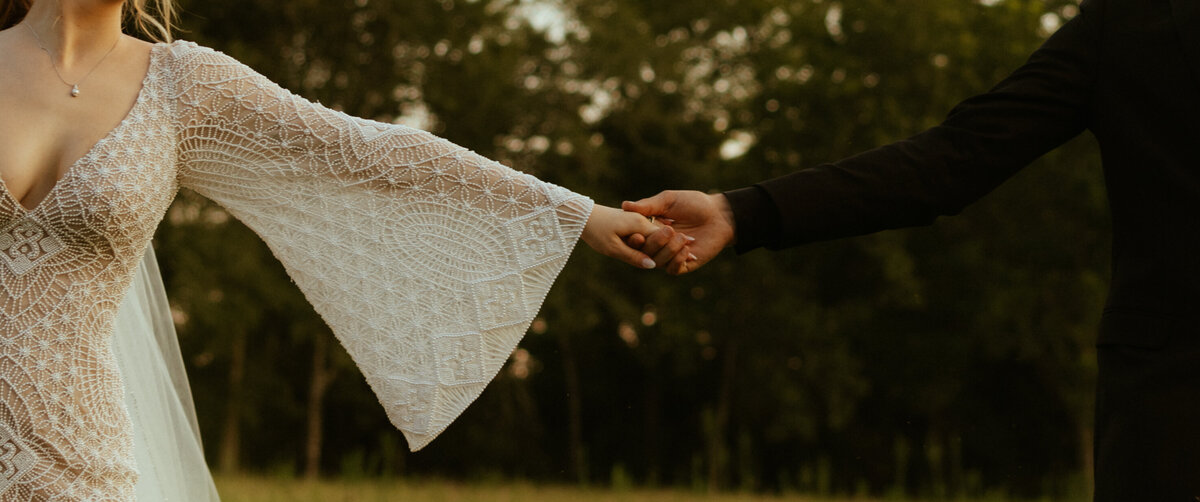 bride and groom holding hands