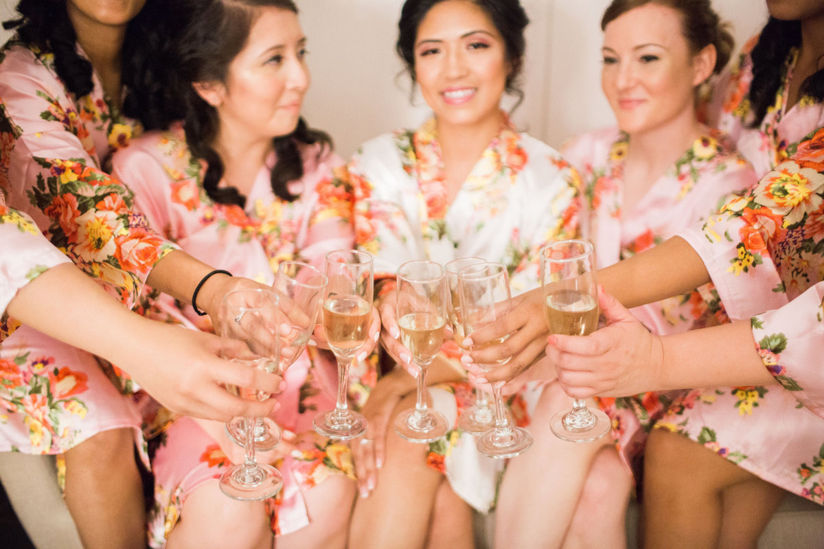 Bridesmaids and bride with champagne while getting ready at The Norfolk Botanical Gardens