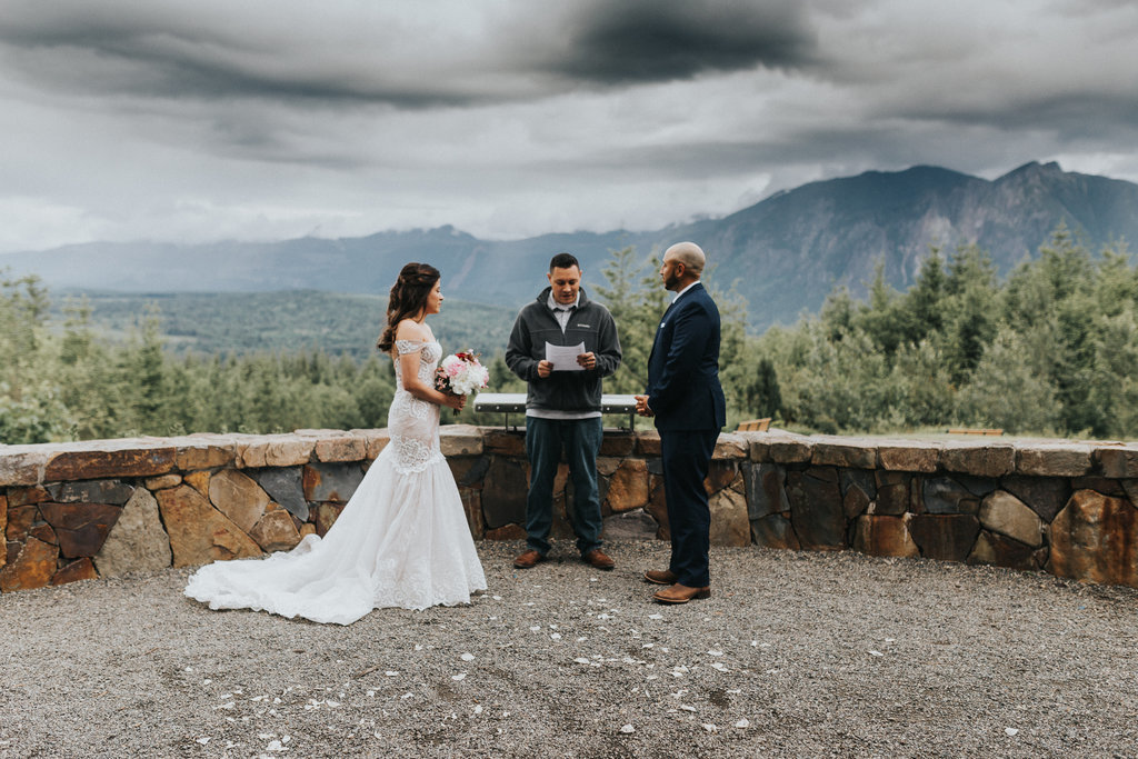 An elopement couple say their vows in this mountaintop elopement in Mt. Rainier, Washington.