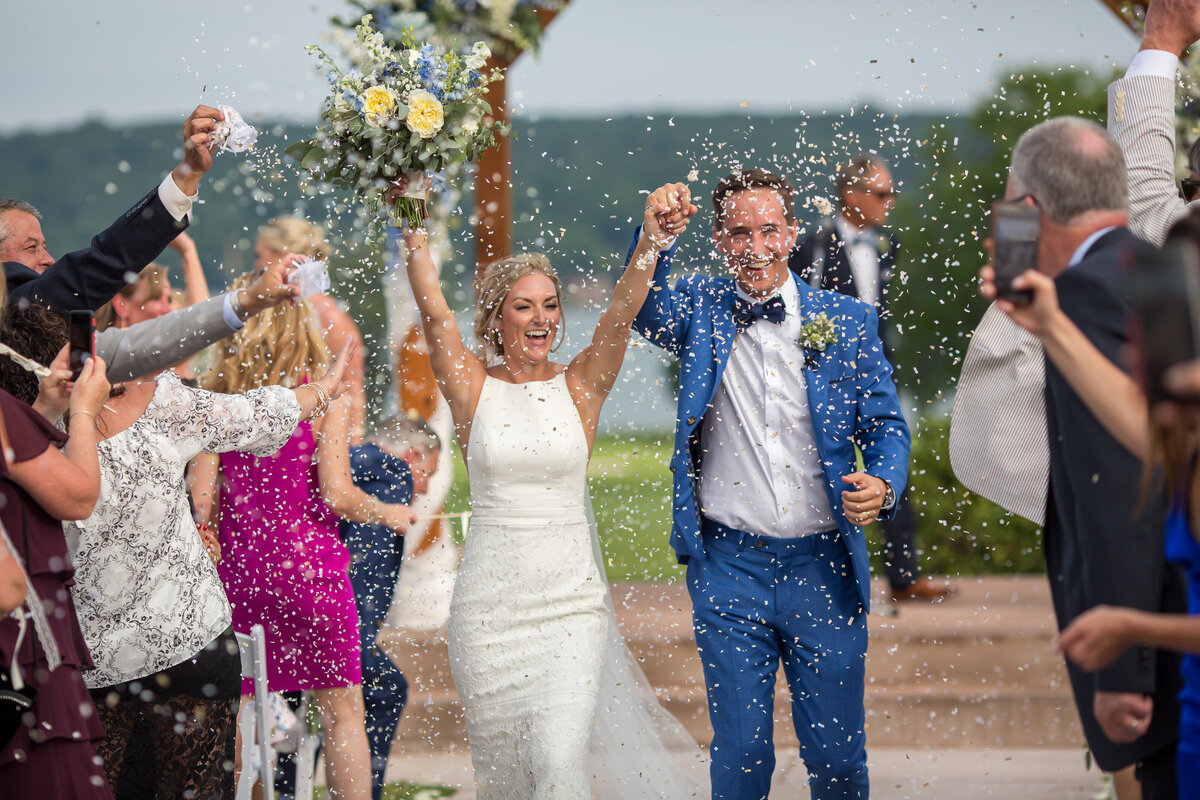 Confetti exit at an outdoor wedding ceremony at the Geneva National Resort in Lake Geneva