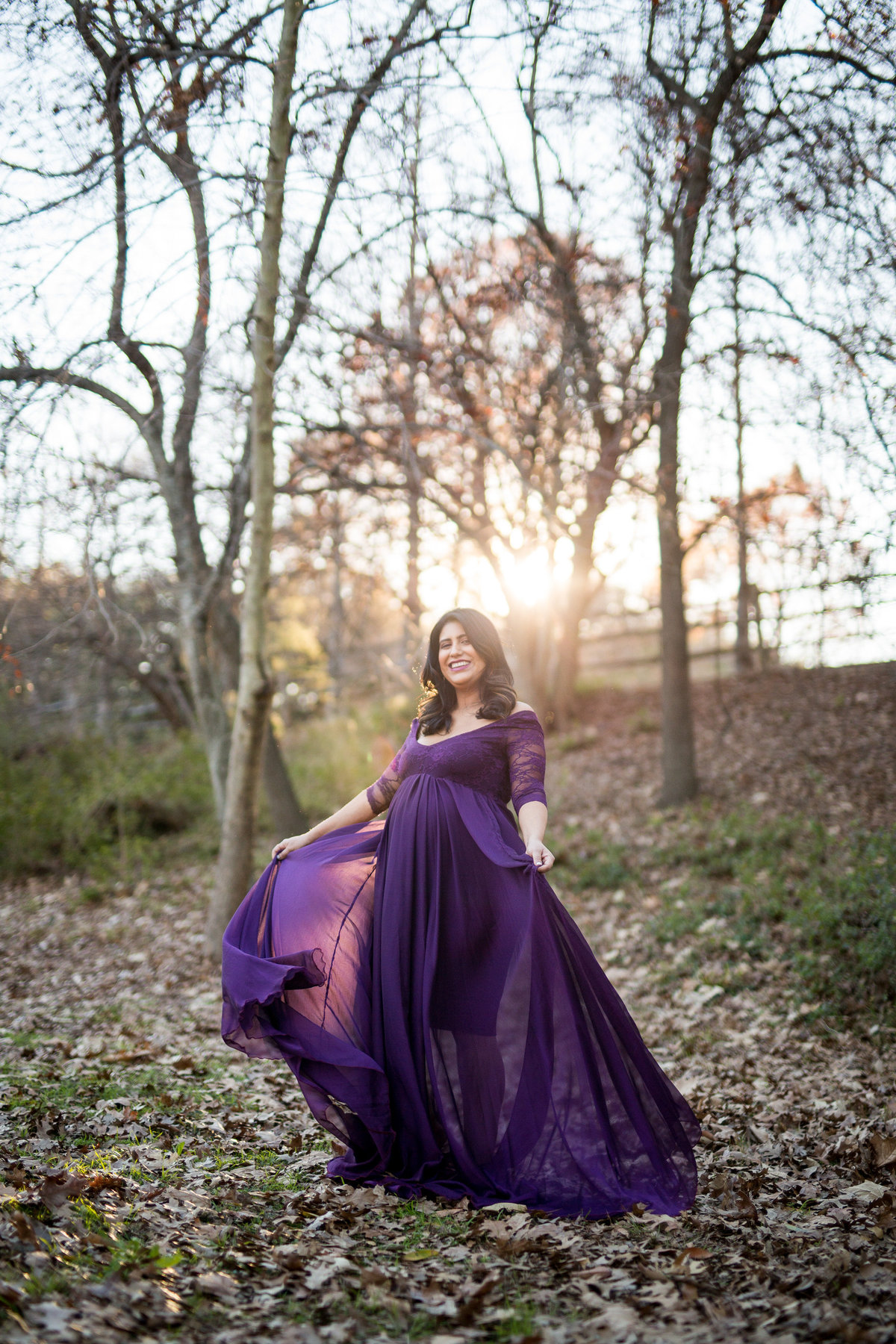 woman in purple maternity dress at sunset for her photography session at Denman Estate Park in San Antonio