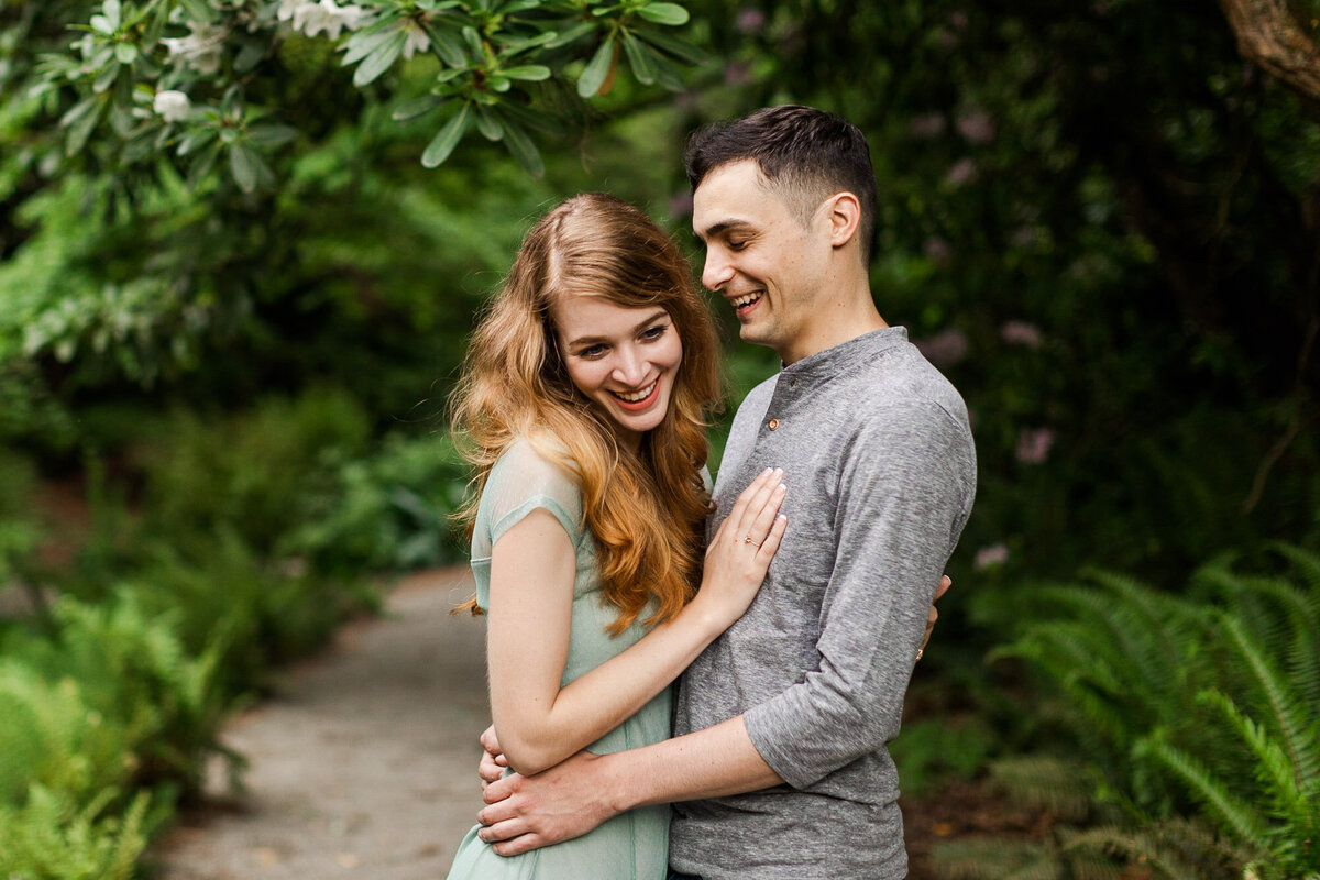 PNW engagement session at Seattle arboretum happy couple smiling and laughing colorful fun candid photo by Joanna Monger Photography