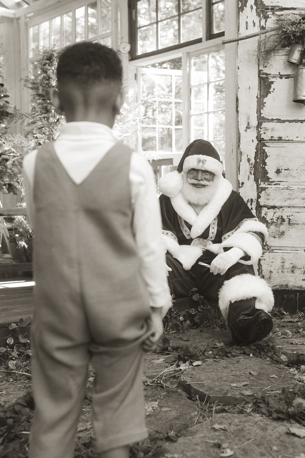 A little boy walking towards Santa at Das Hinterhaus.