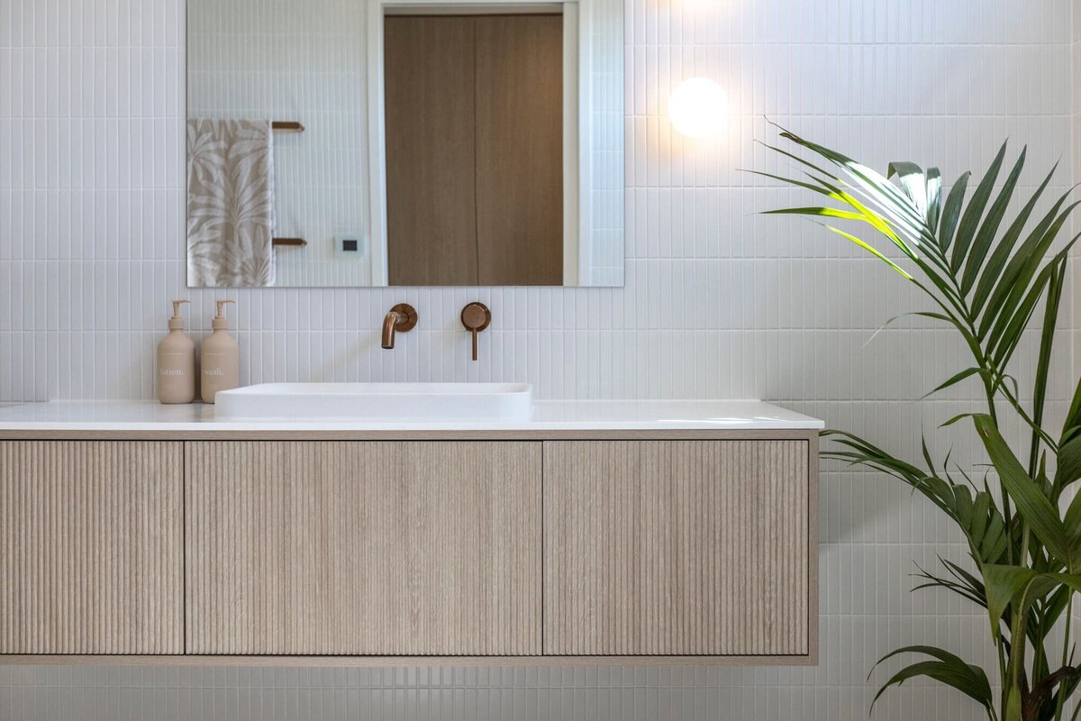 Modern wooden style bathroom with brass taps