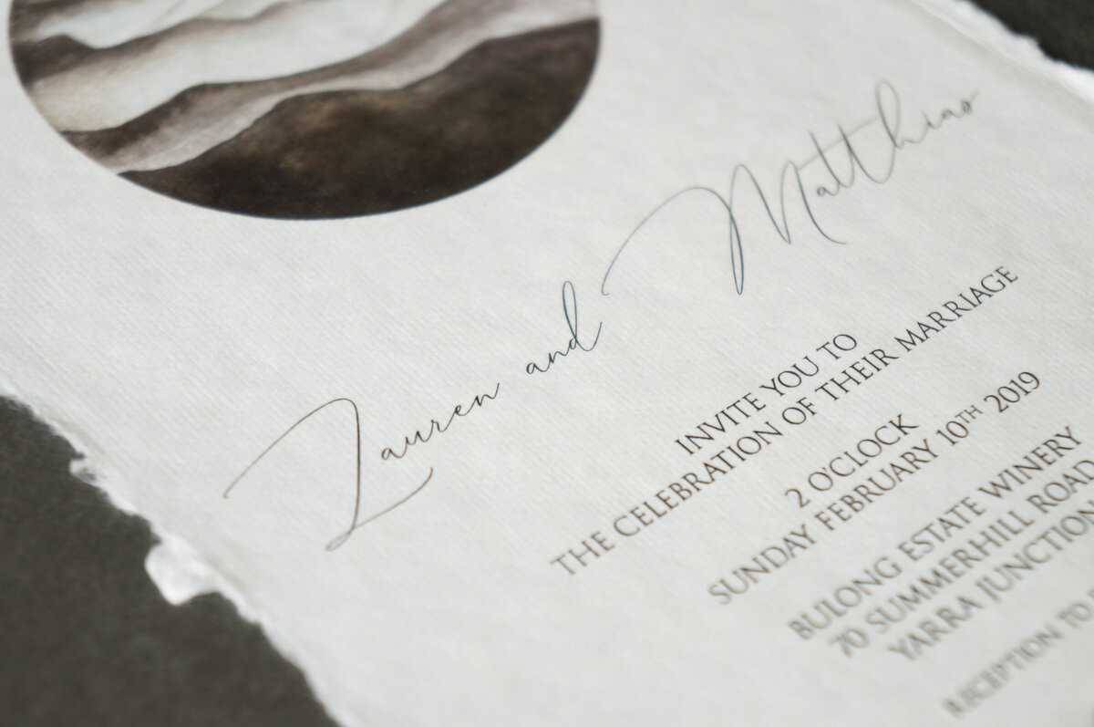 Classic contemporary wedding invitation with mountains design and cursive font on handmade cotton paper