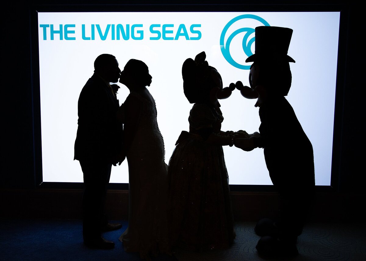 Mickey and Minnie pose with newlywed couple at Living Seas reception at Epcot