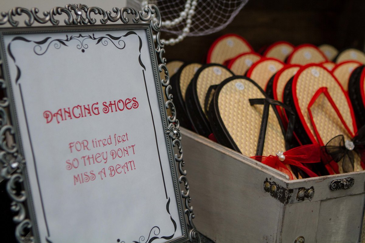 basket of black and red dancing shoes at wedding reception
