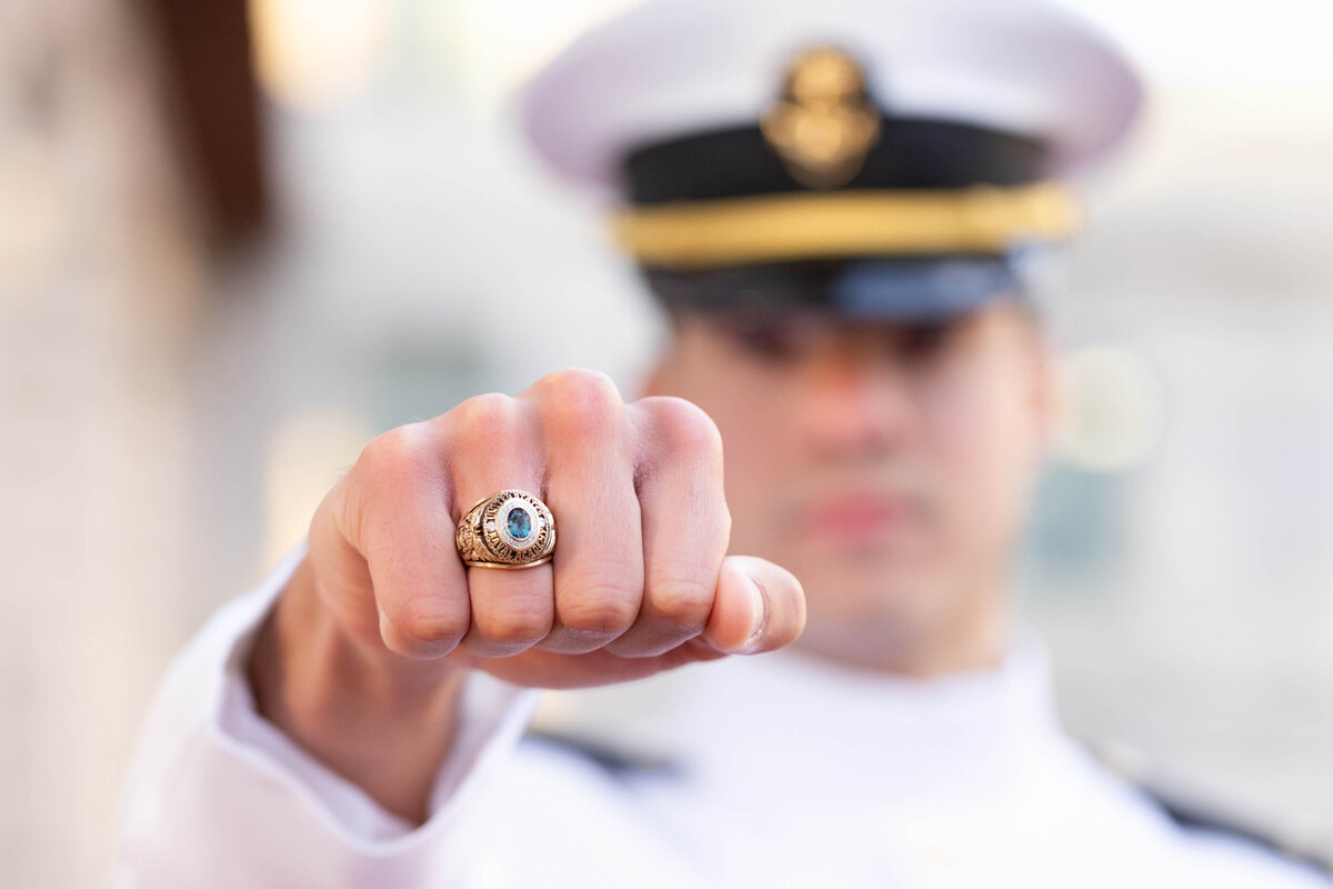 Naval Academy senior shows of class ring before graduation in Annapolis, Maryland.