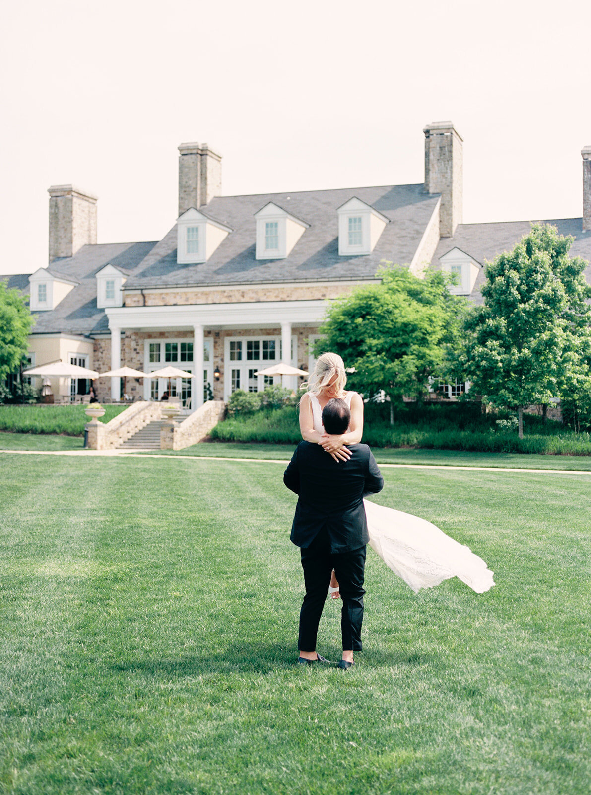 Bride and groom share a fun moment at the lawn of Salamander resort.