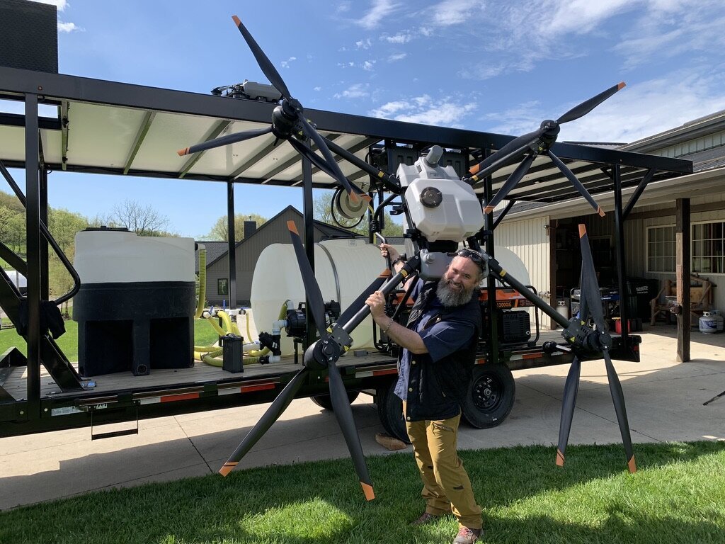 Raven 6 Rising's founder Jason Miller holding the DJI Agras T-40