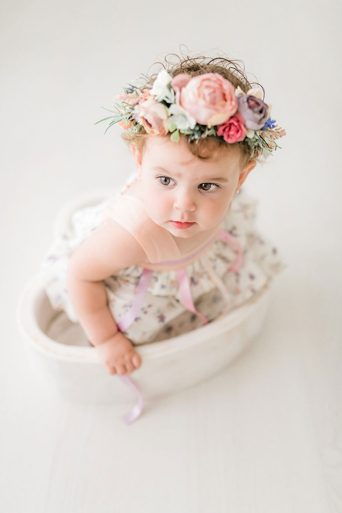 a little girl sitting in a heart-bowl captured by a destin family photographer