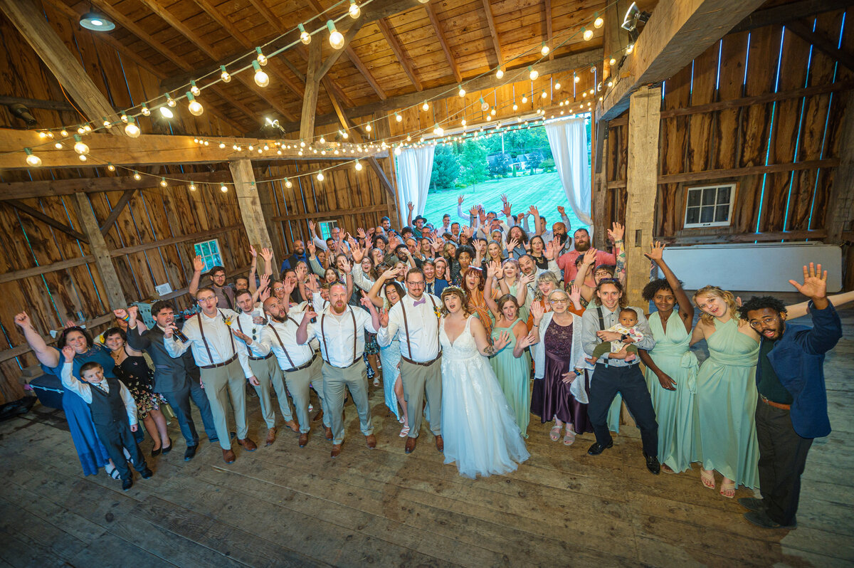 Wedding crowd cheering at a barn reception