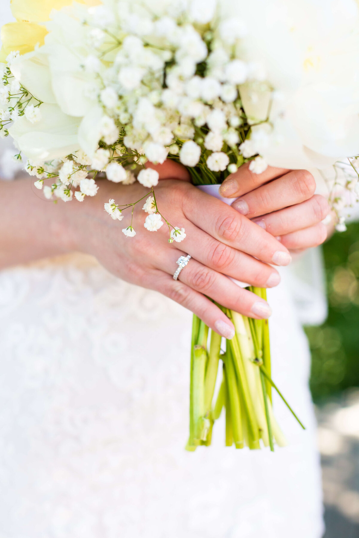 Close up of bride holding bouquet of florals