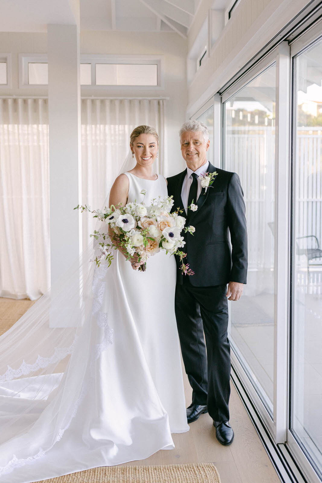 bride with her bouquet and father of the bride