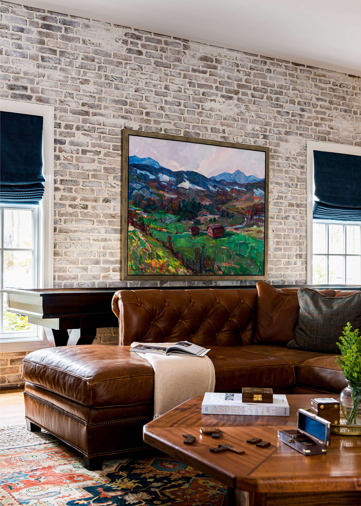sweet southern home windmill painting on brick wall in living room