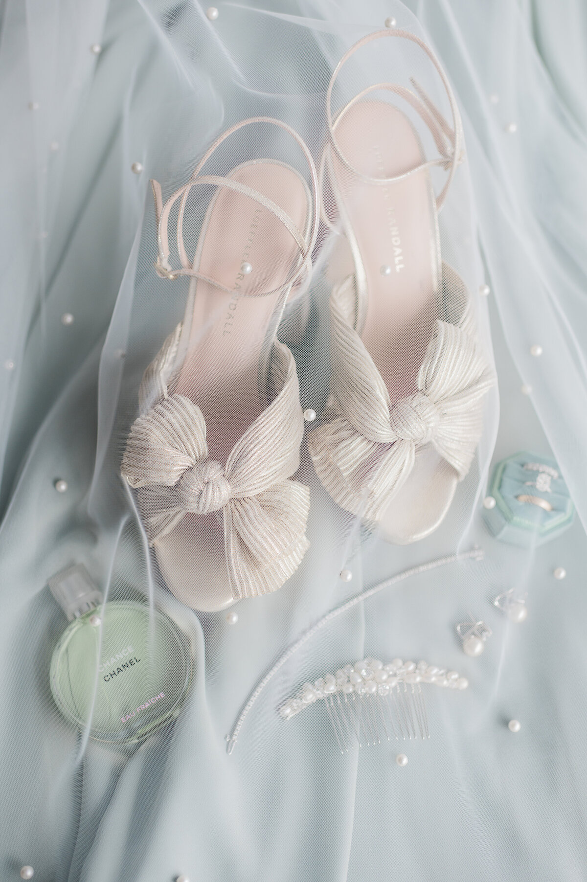 heels and perfume underneath a translucent wedding veil