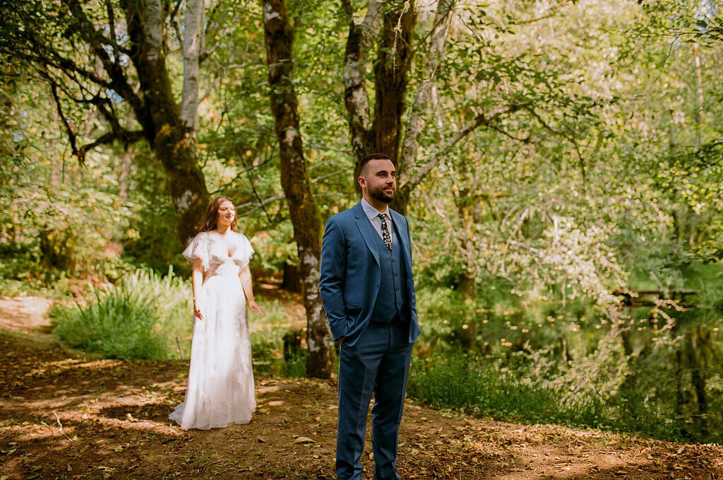A bride and groom first looks before their vintage garden wedding in Oregon.