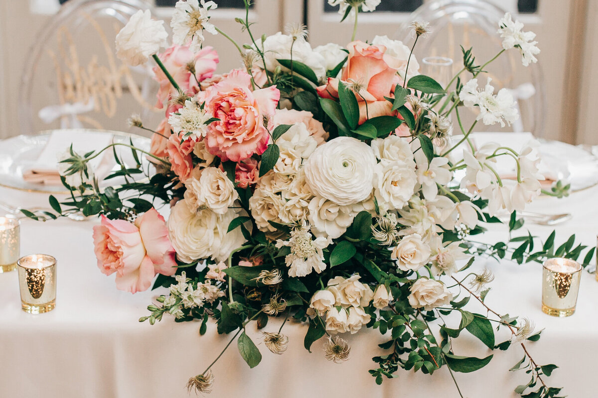 Luxurious pink and white floral centre pieces with roses, chrysanthemums, and eucalyptus