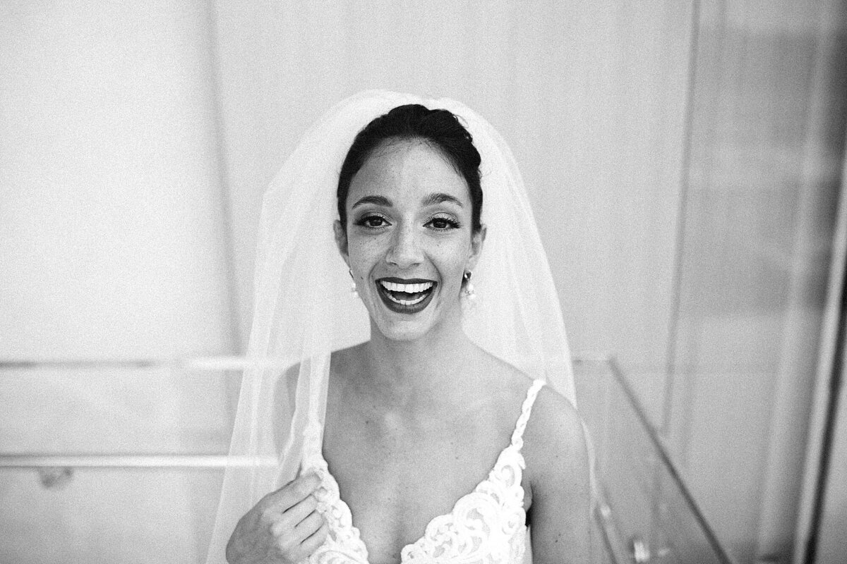 Black and white image of bride laughing