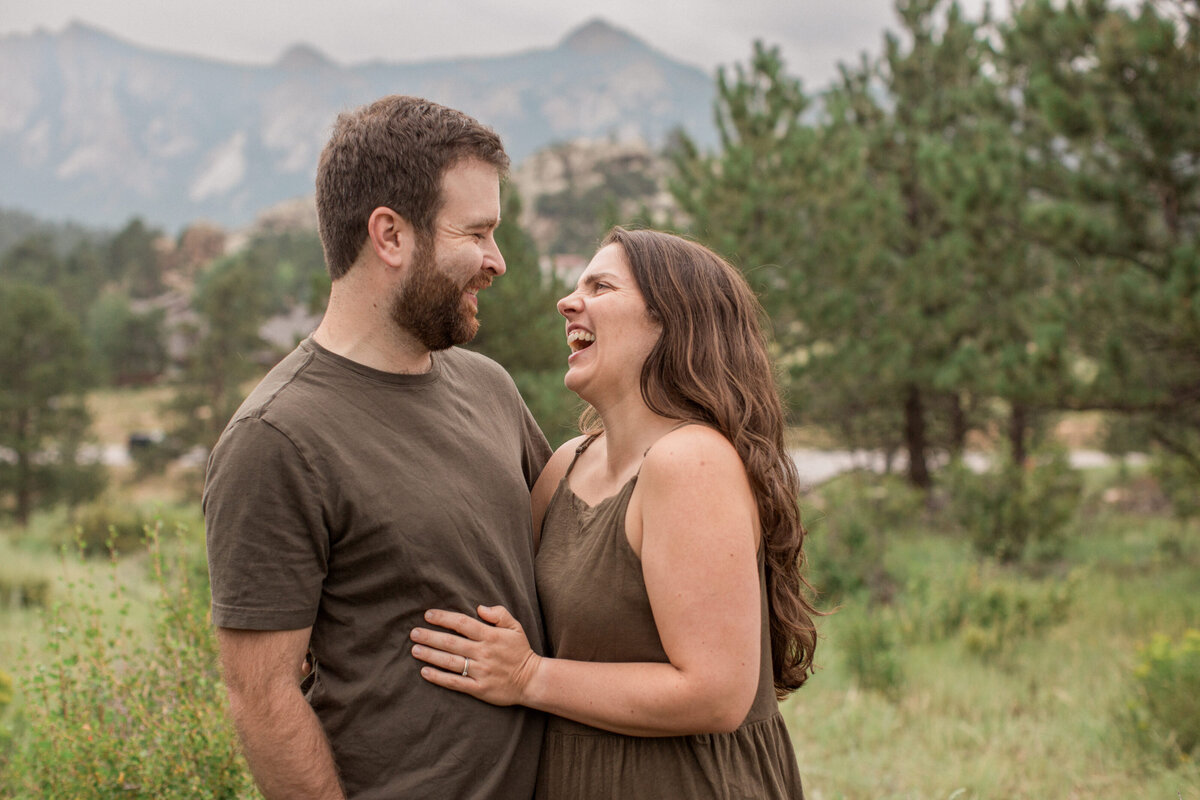 A couple in love embrace each other at their photography location near the Stanley Hotel in Estes Park Colorado