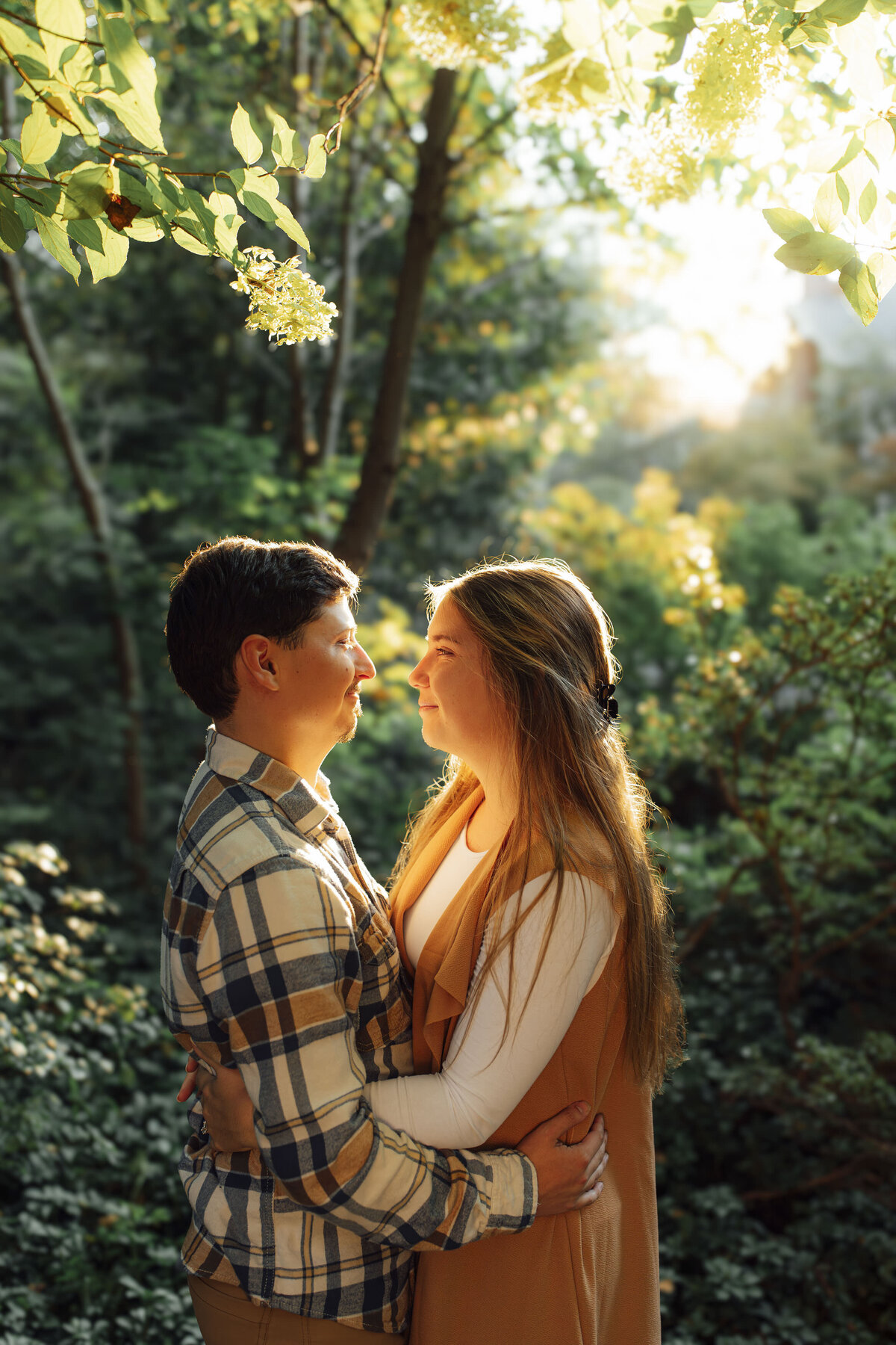 Couple hugging during sunset engagement photo at Sayen House and Gardens in Hamilton Township New Jersey