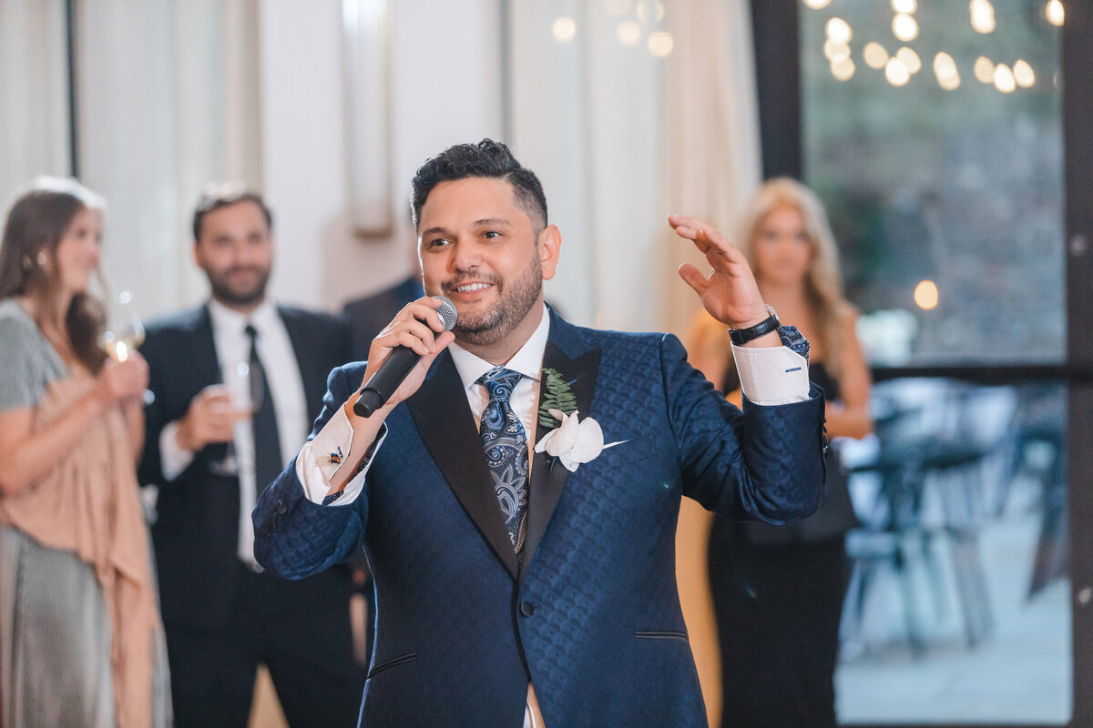 groom giving speech during reception