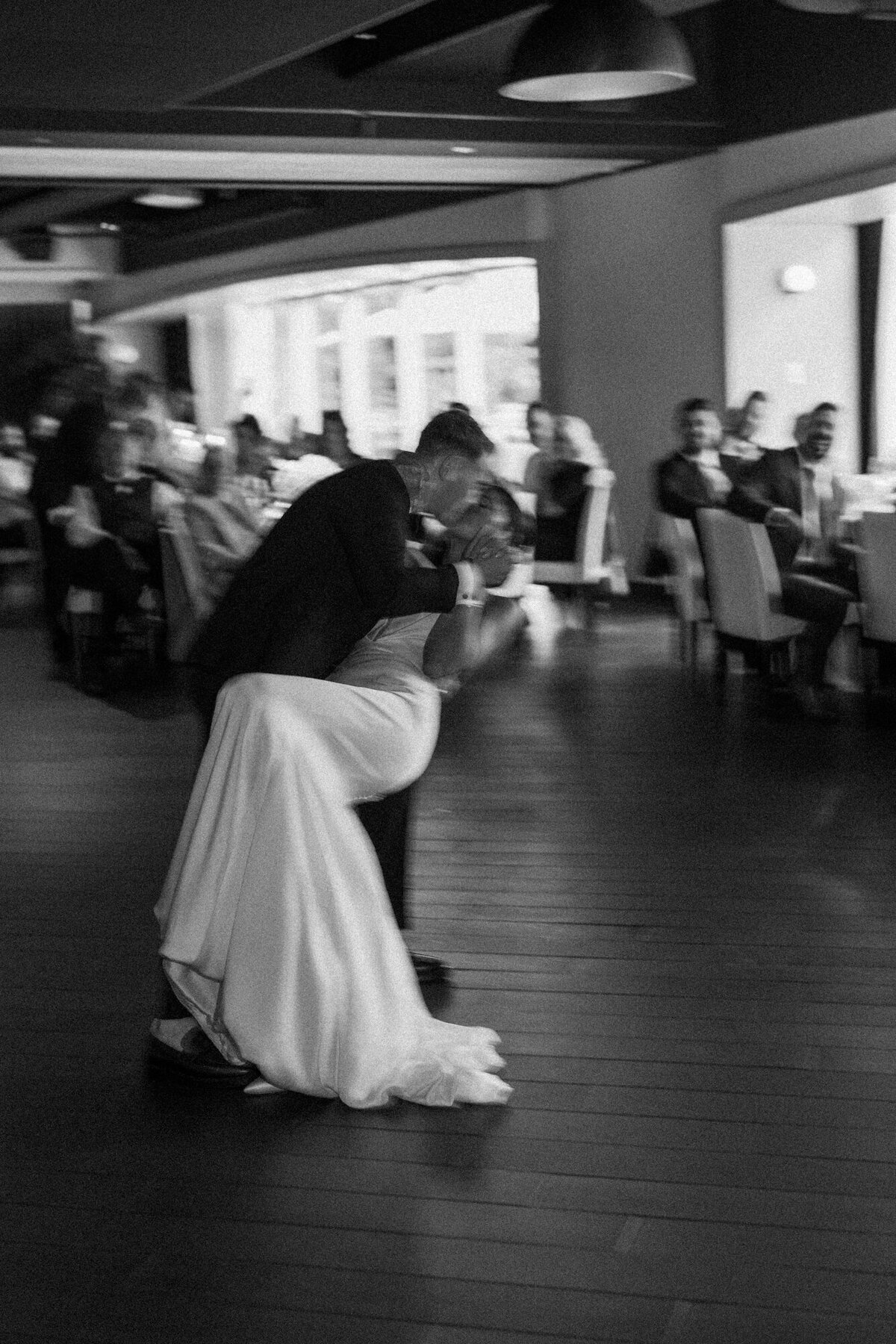 A moody, film-inspired black and white wedding photo capturing a romantic, softly blurred first dance at RPM Events.