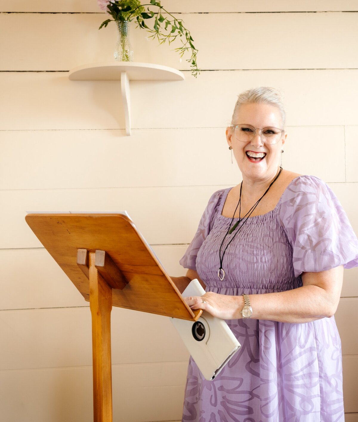 Smiling wedding celebrant in Auckland creating relaxed, love-filled wedding vibes