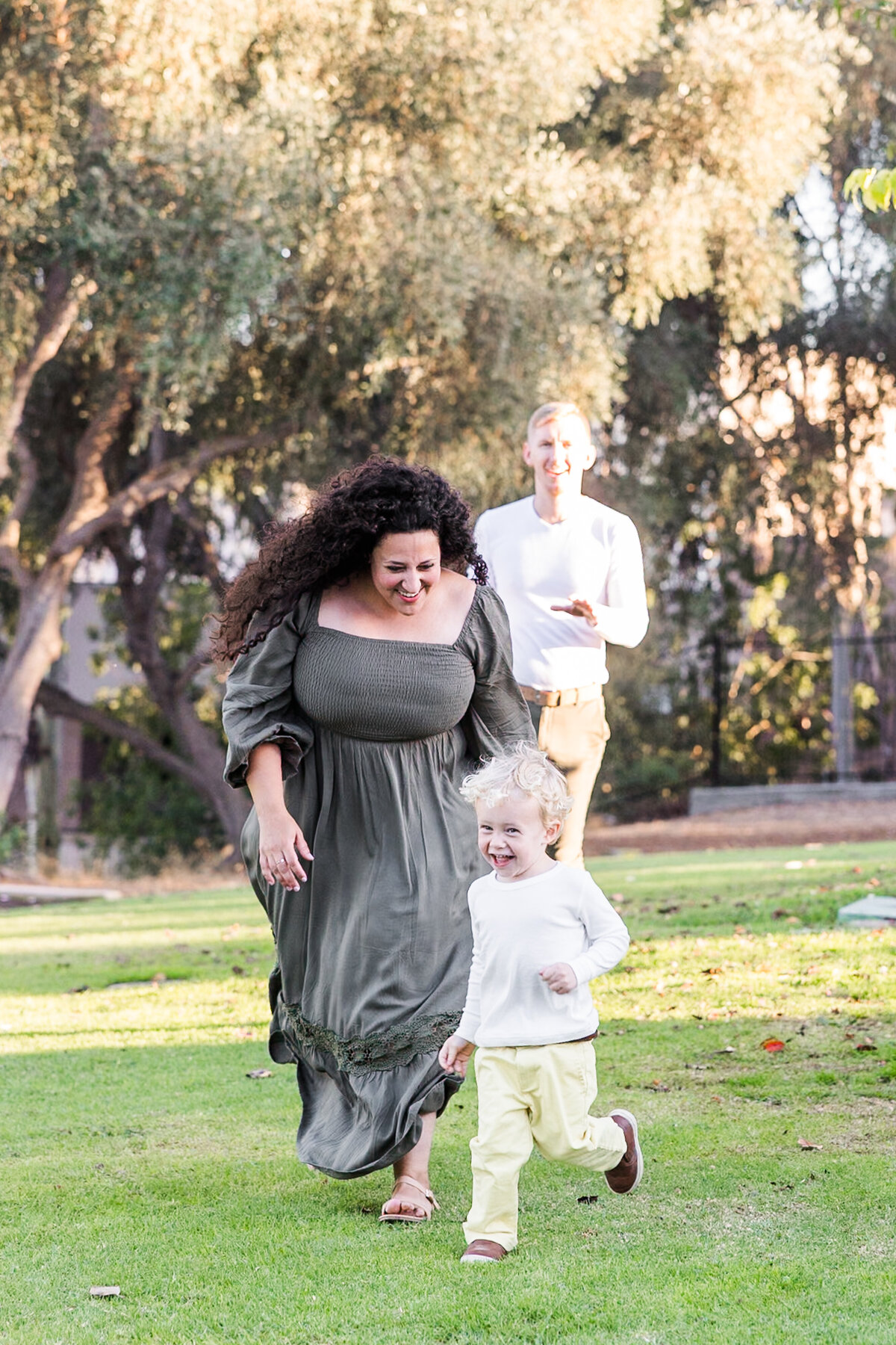 mother chasing young son in san diego park