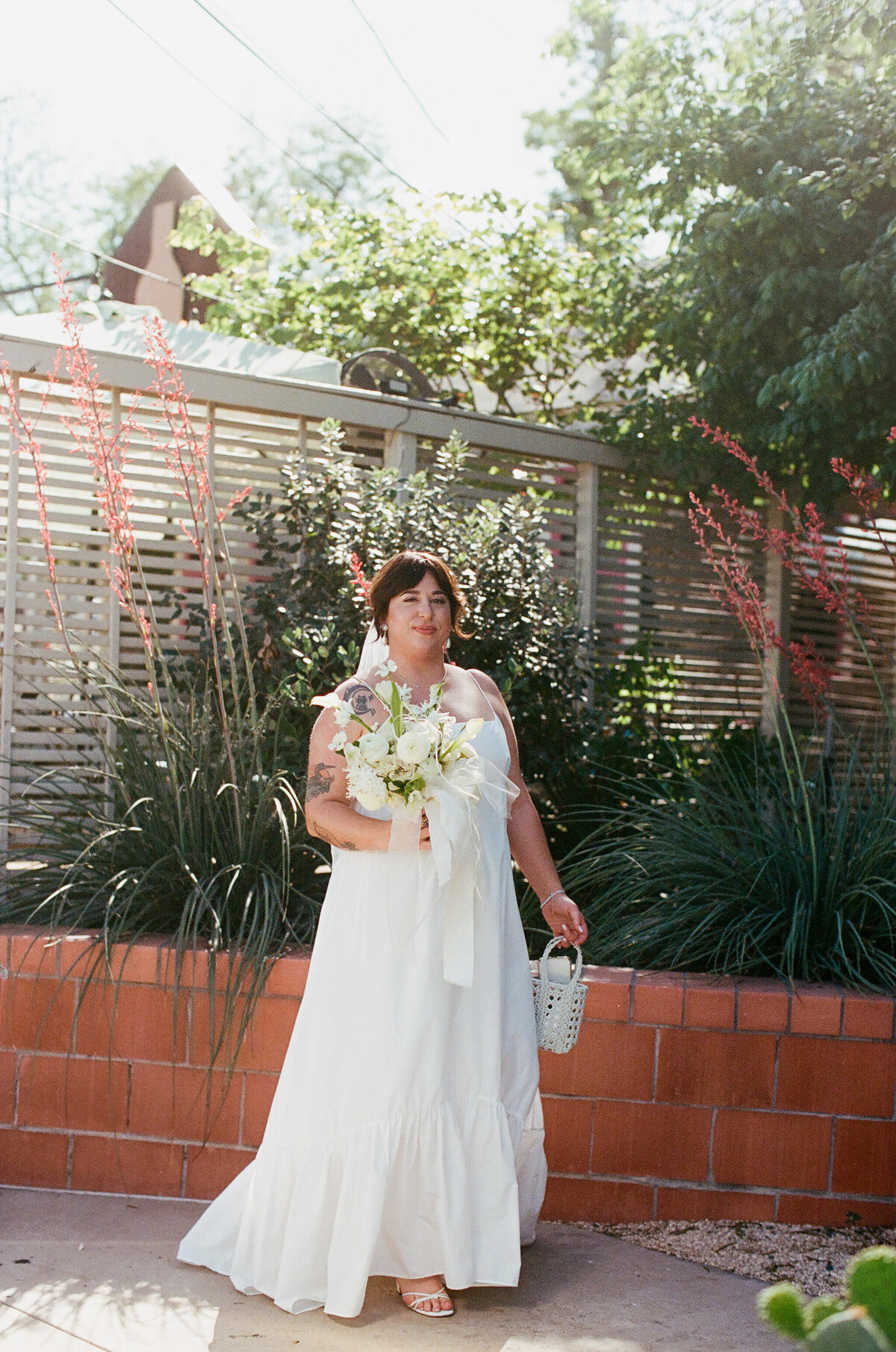 Bride holding white bouquet of florals