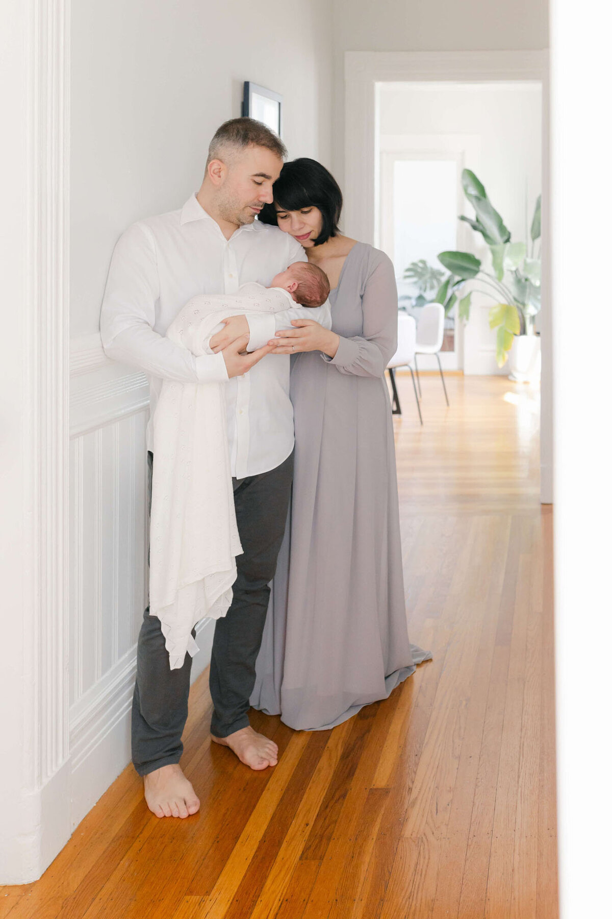 Cozy living room Bay Area newborn photography session with baby wrapped in a blanket.