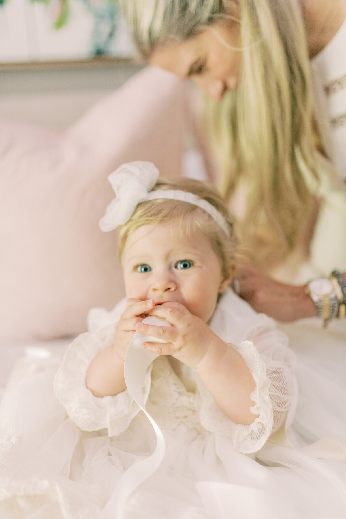 Natural light falls gently on mother and baby, their shared joy echoing in this quiet, intimate scene.
