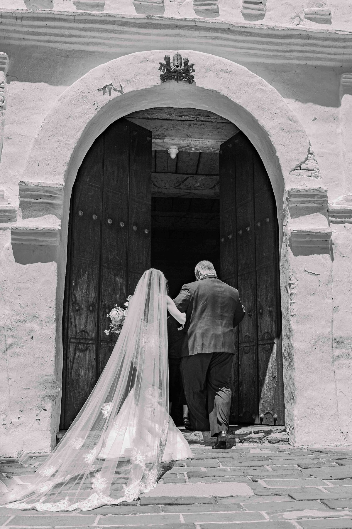 bride-and-father-entering-mission-san-diego