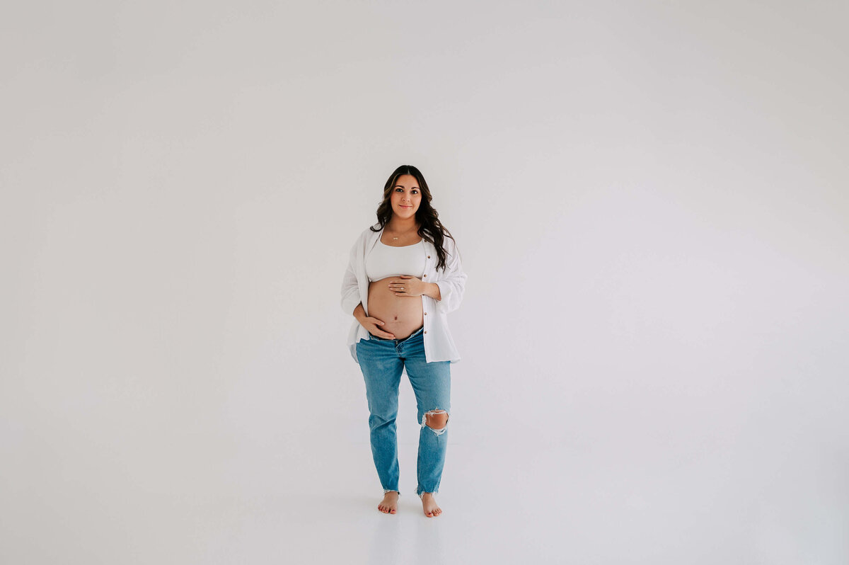 pregnant mom in jeans  during Springfield Mo maternity photography session