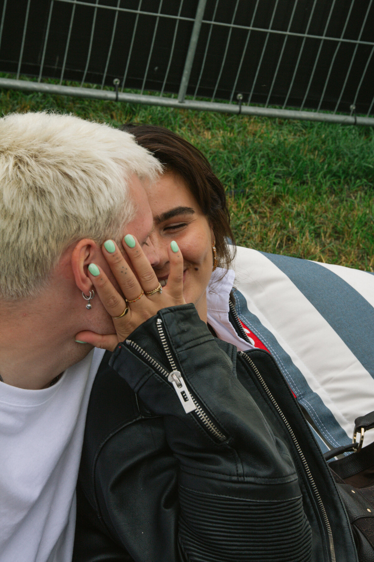 An intimate moment between Sam Hofman and a friend during a festival, with a smile captured by photographer Bo Eppink.