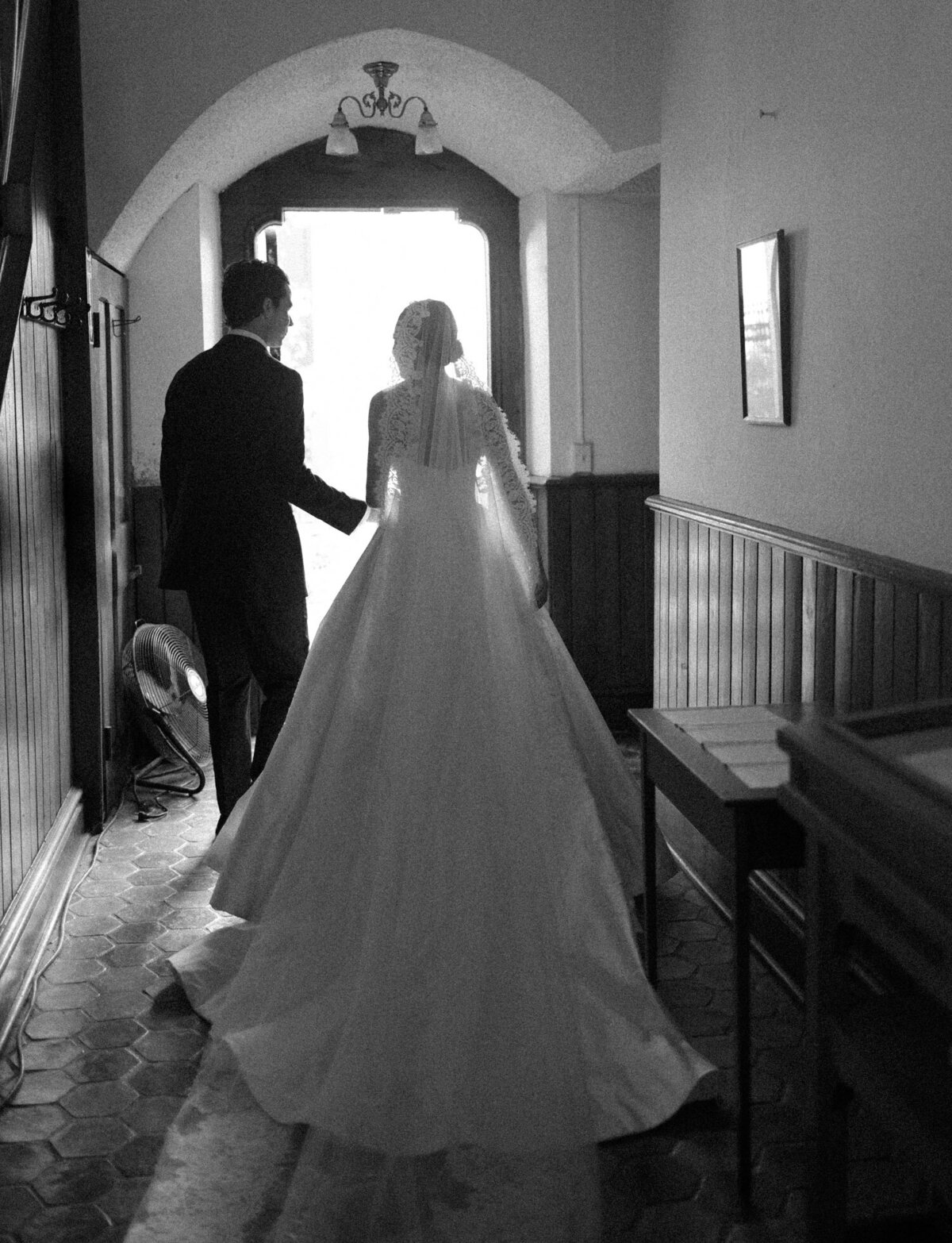 stunning grainy black and white film wedding photography in Detroit shows a couple exiting Christ Church just after being married