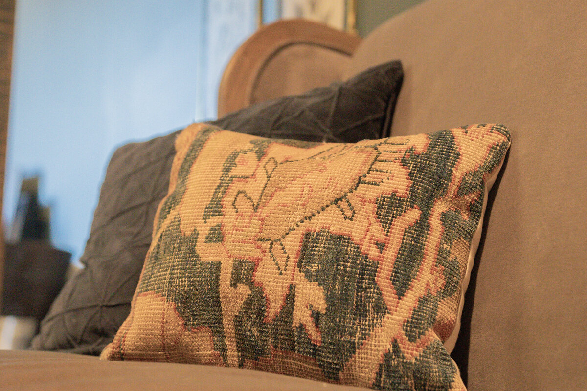 Grey velvet sofa bench with velvet pillow and one of a kind antique persian rug pillows