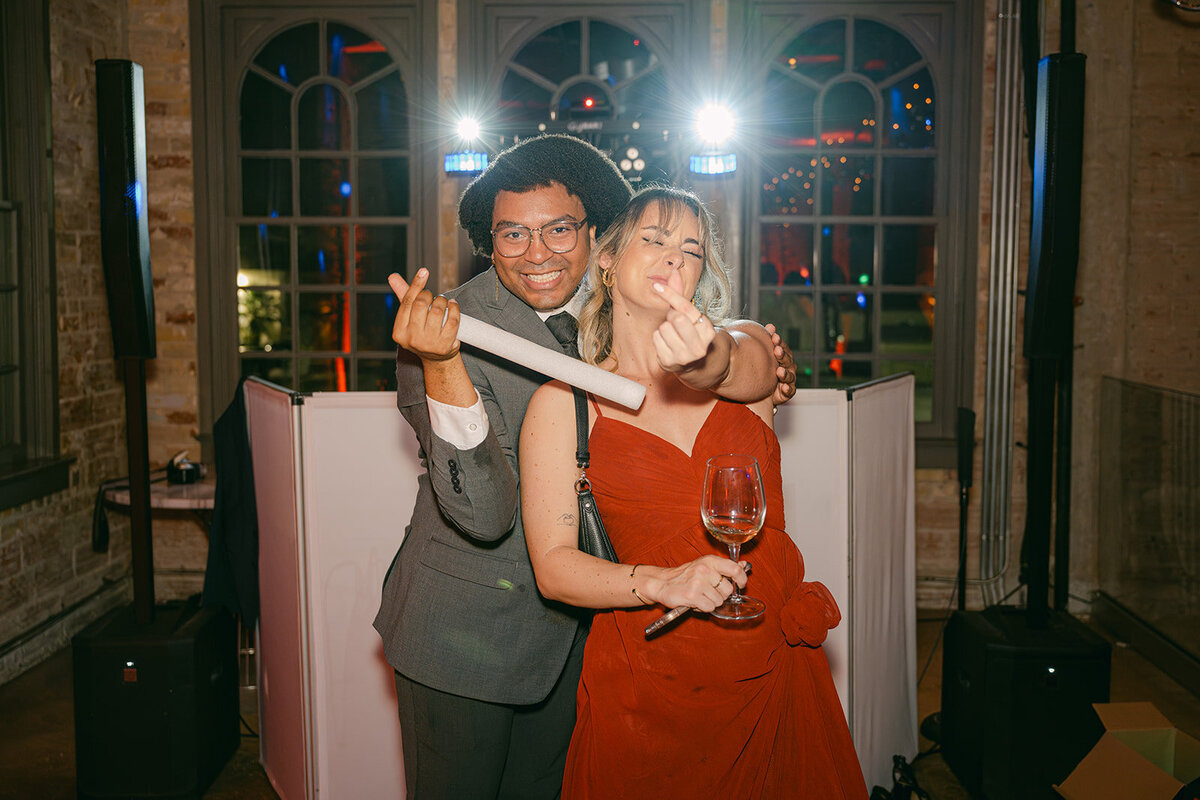 Guests celebrating with glow sticks on the dance floor during luxury wedding reception at The Battalion in downtown San Antonio