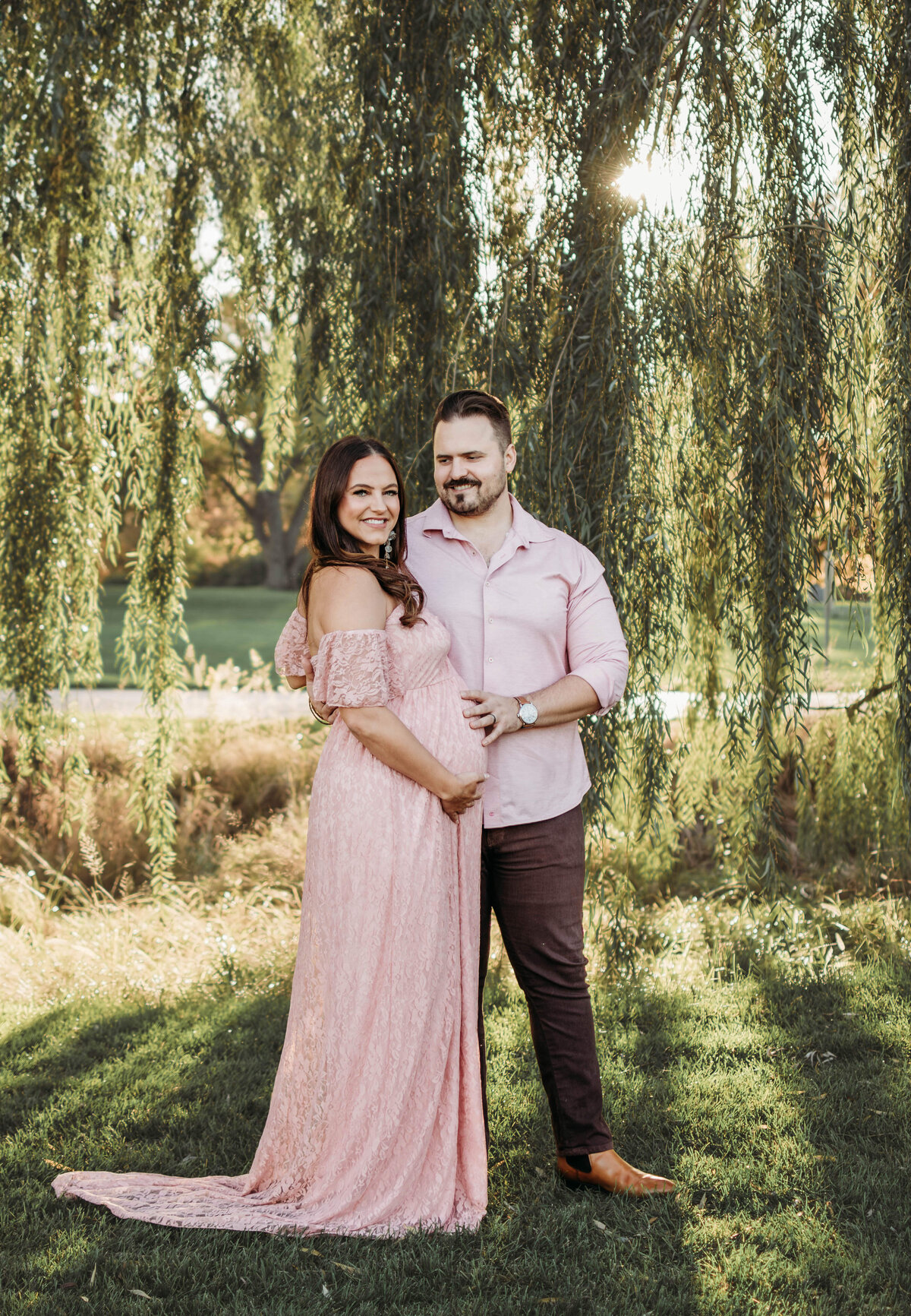 Mom and dad to be sharing the love under a willow tree in Wheaton, IL