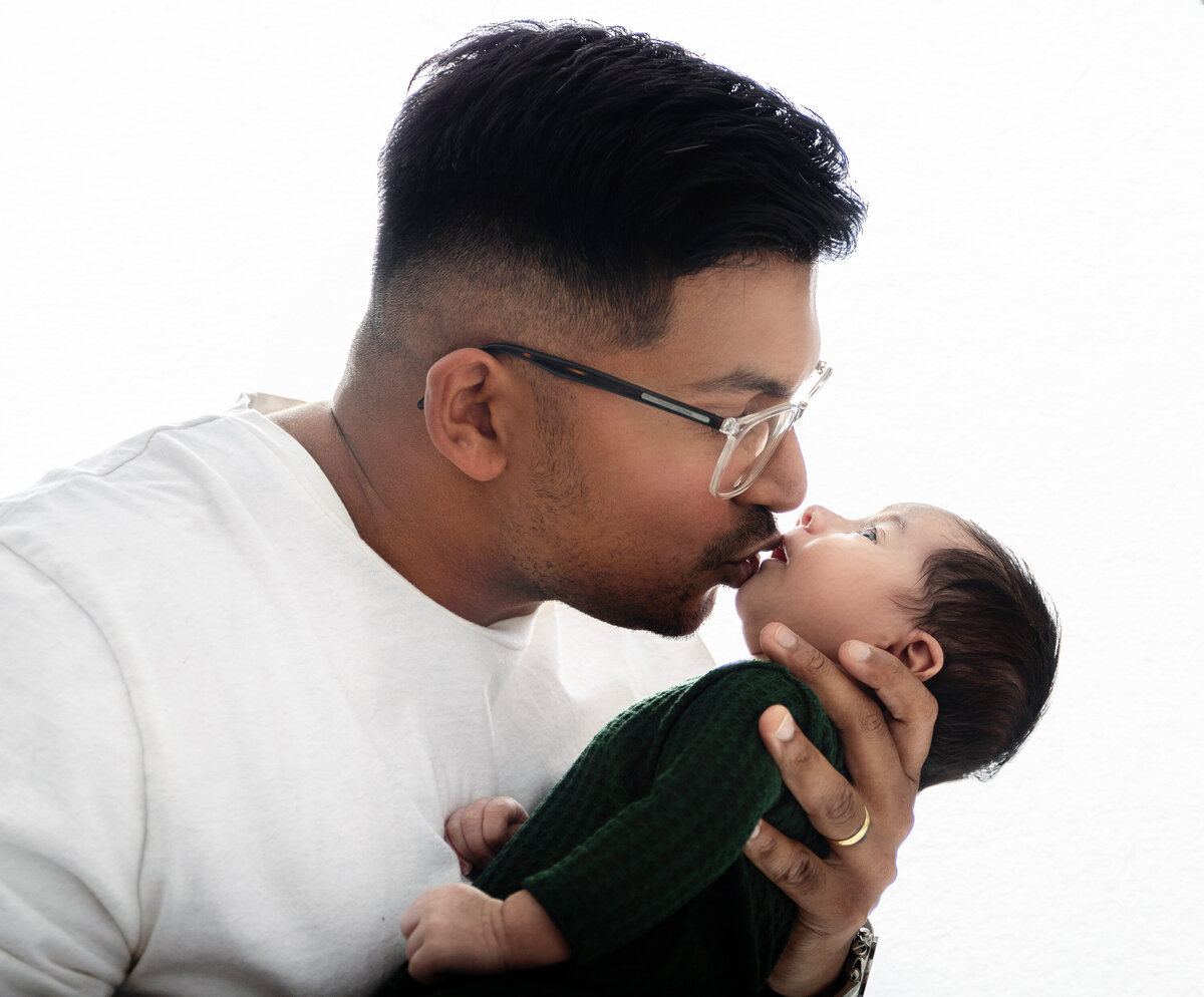 Dad and newborn son backlit photo