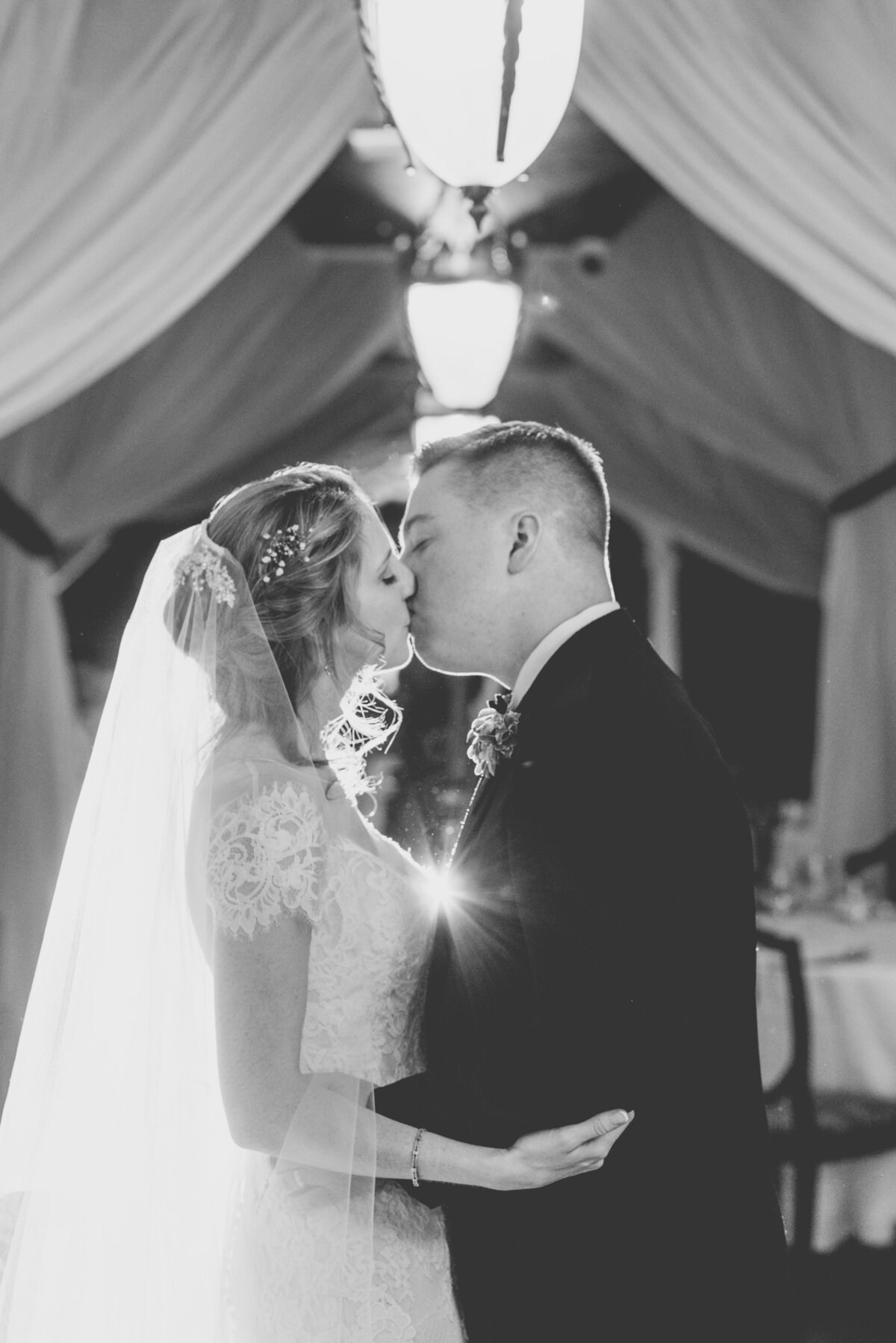 black and white wedding photo of bride and groom kissing at The Carltun