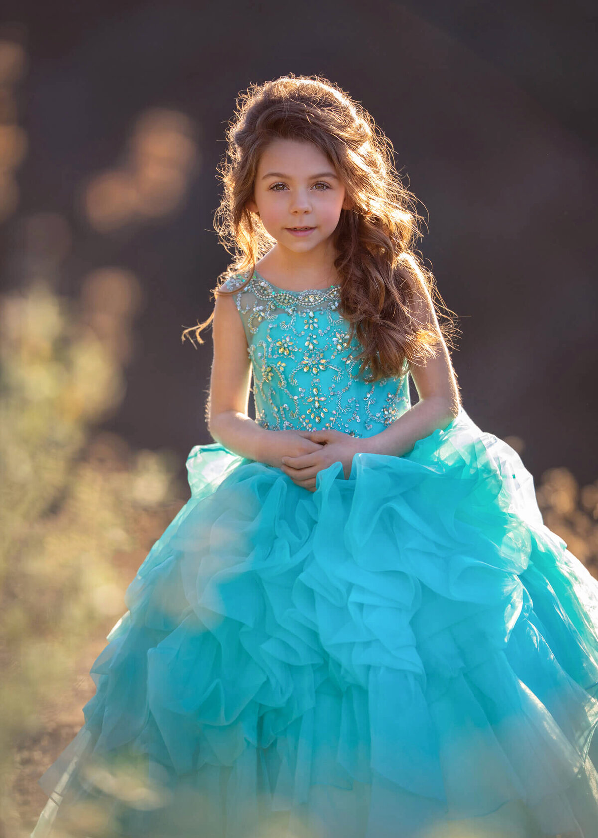 Girl in blue dress with the sun setting behind at Encino Park