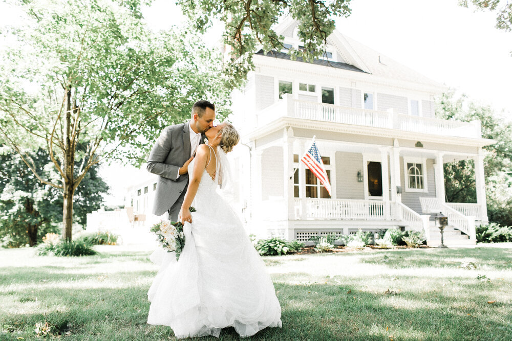 Wedding couple kissing before their wedding reception at the Historic Walsh House