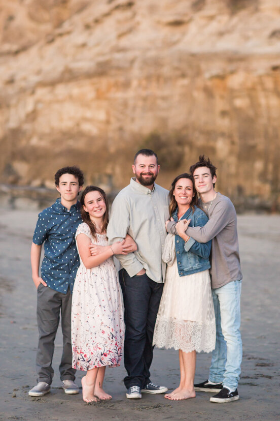 family-hugging-on-beach-la-jolla-san-diego