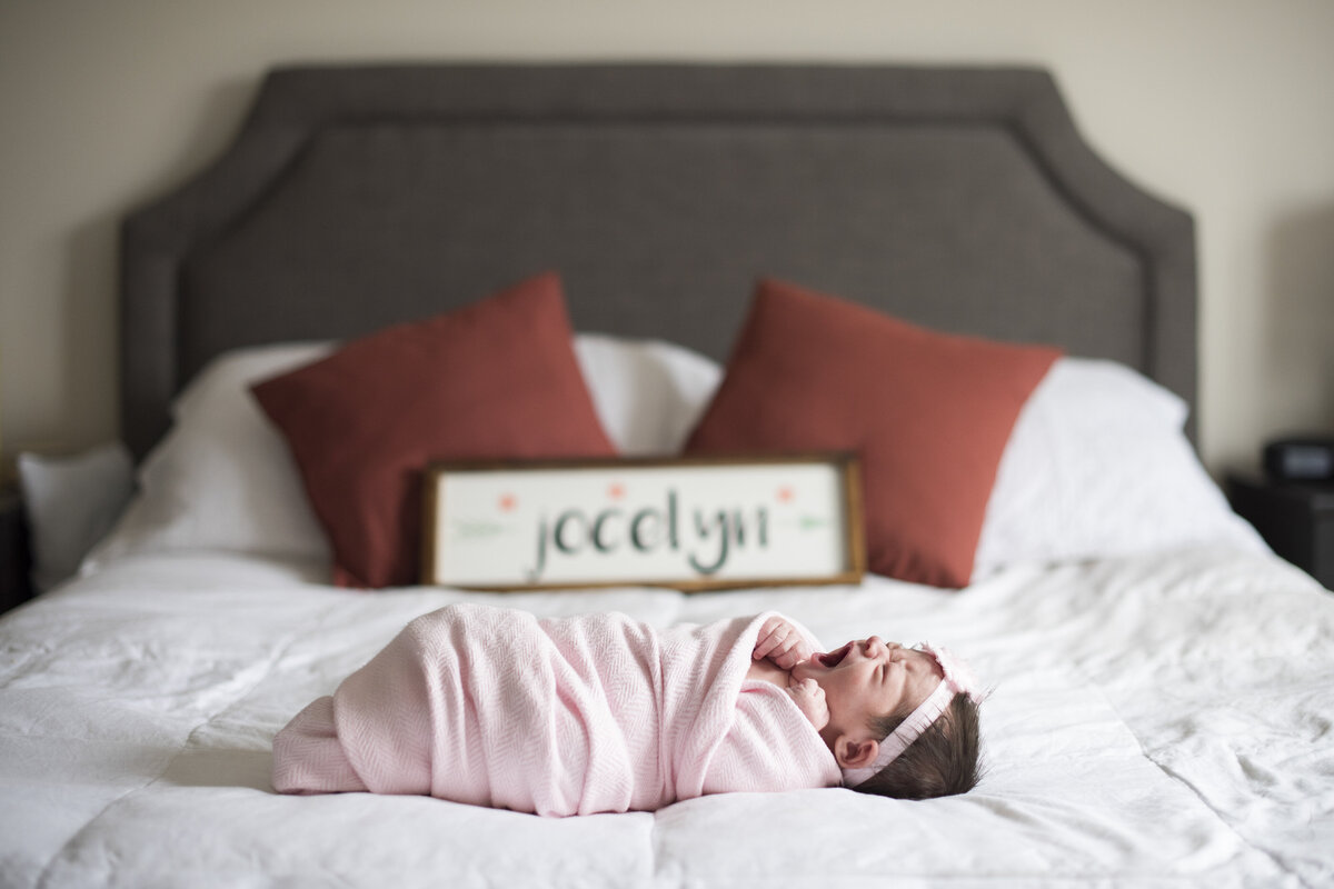newborn baby on bed at home photography asheville nc