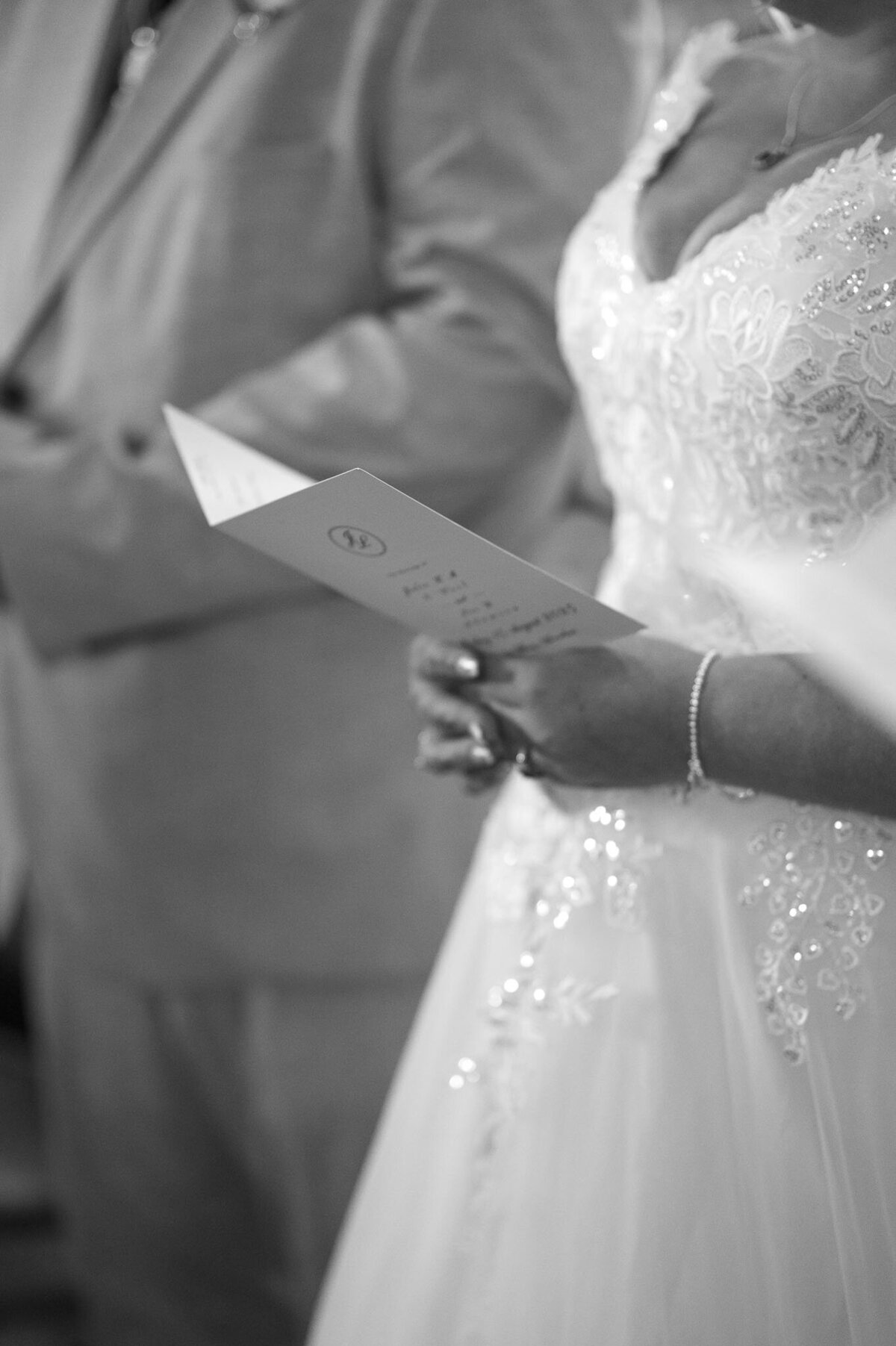 detail photo of bridal dress during ceremony - Wedding Photography