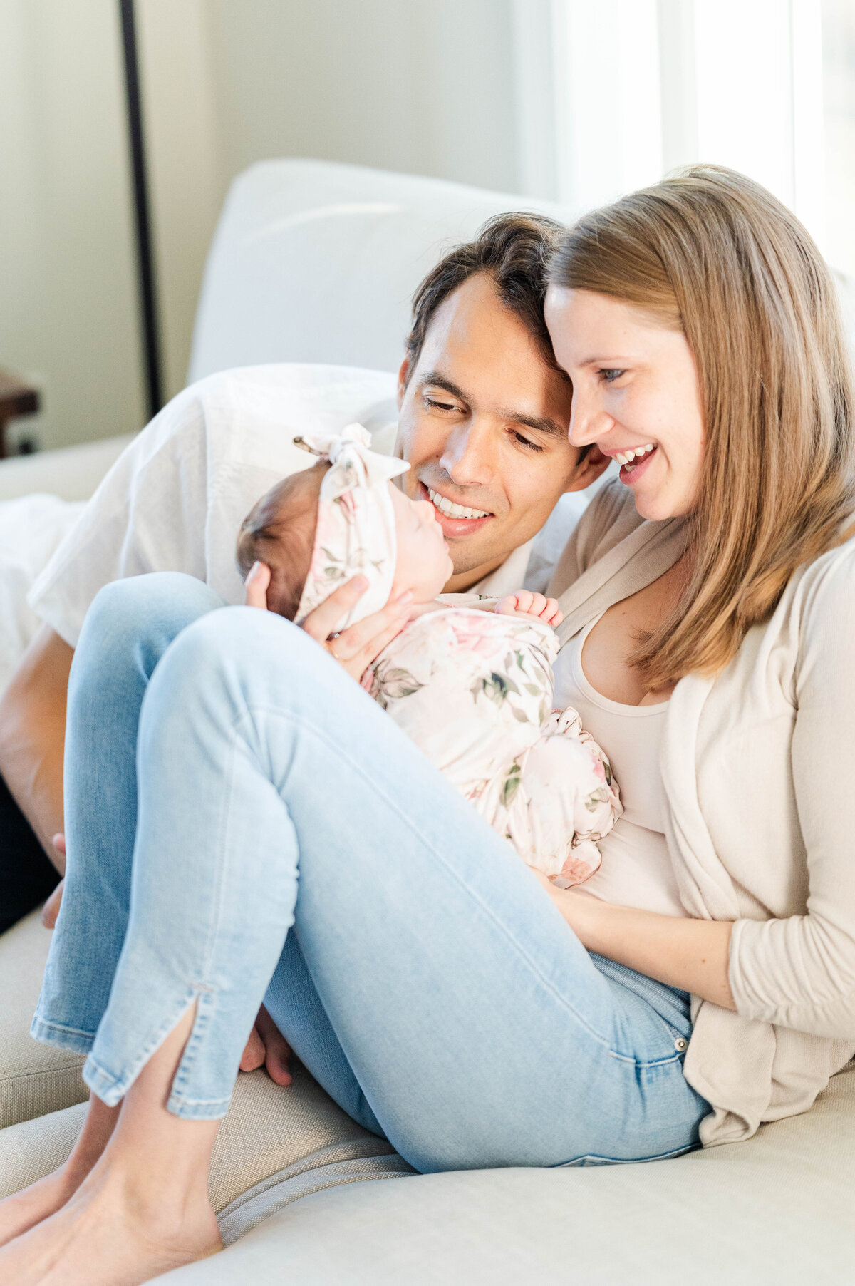 Mom and dad staring down at newborn taken in Westwood, MA by best Westwood newborn photographer