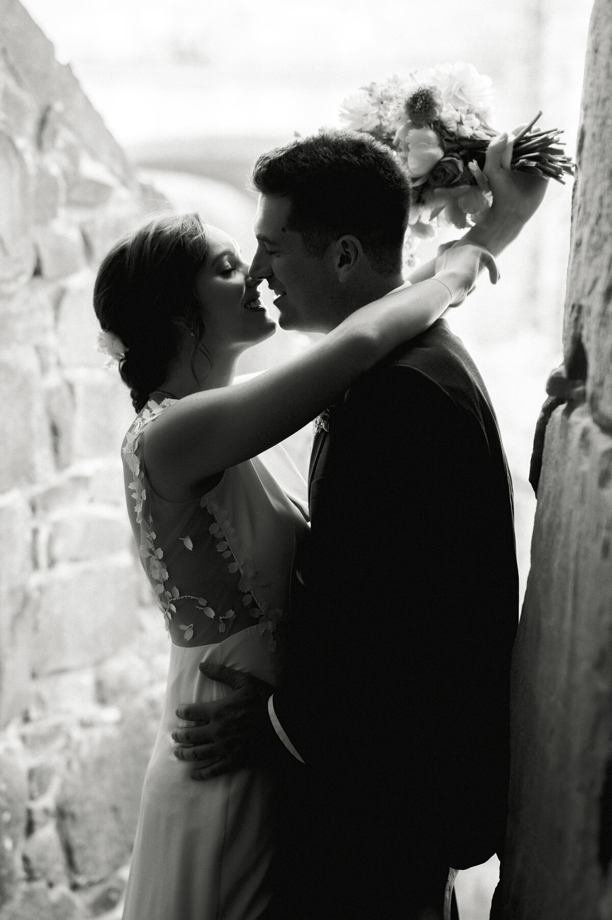 romantic black and white portrait of bride and groom kissing at ladybird johnson wildflower center by austin wedding photographer