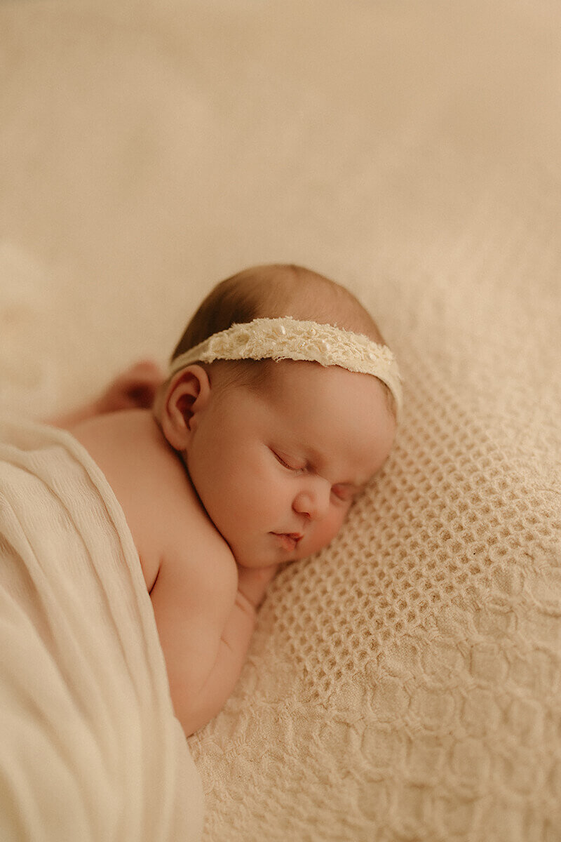 Newborn baby wrapped in soft blanket during in-studio session Nashville TN