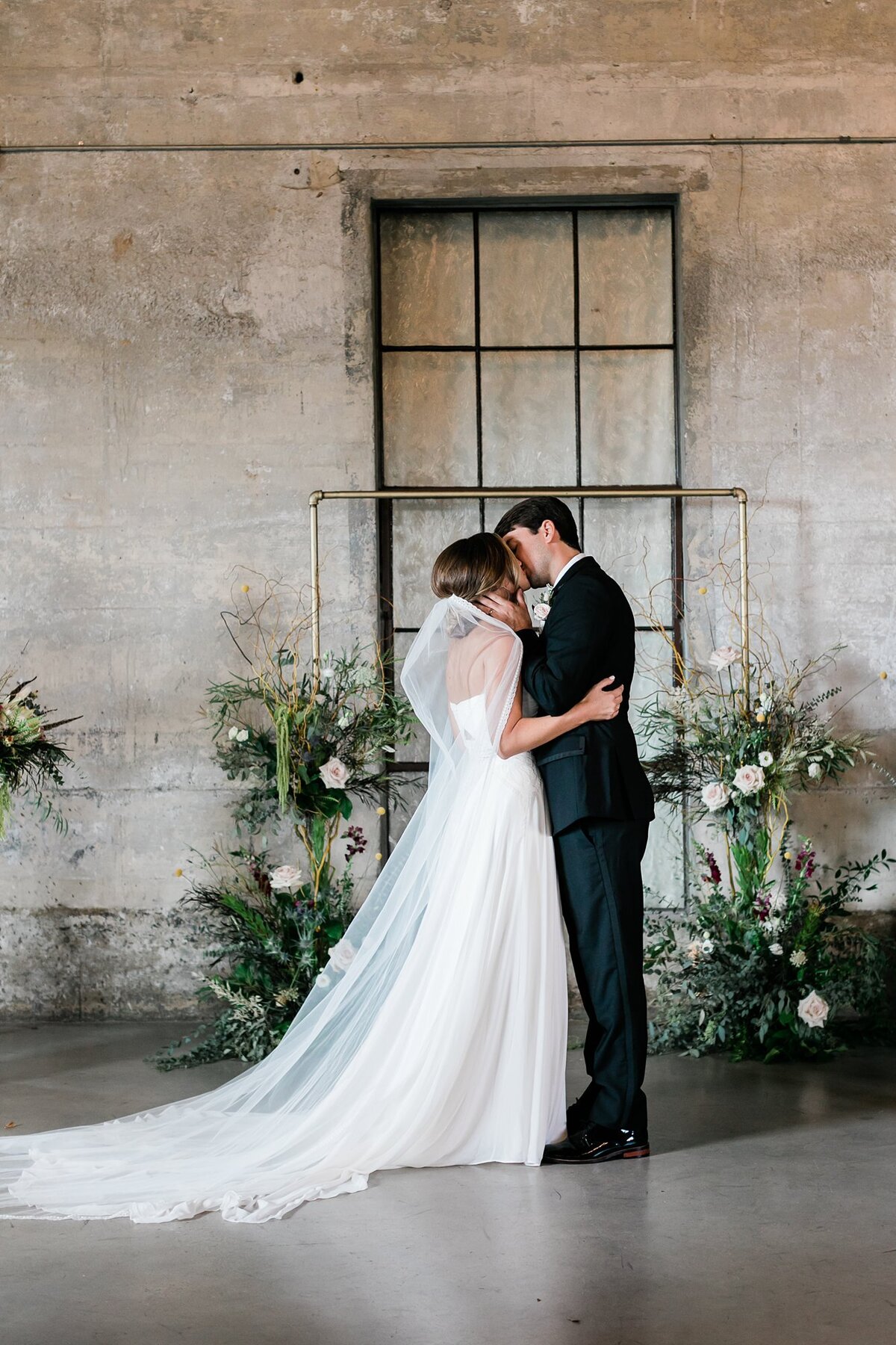 Bride and groom's first kiss at Olde Dobbin Station